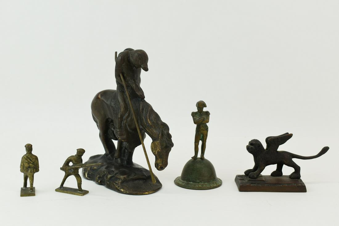 Five Small Metal Figurines: Five Small Metal Figurines, comprising a copy of a Remington sculpture bookend, a Napoleon form bell, a Saint Mark's lion, and two soldiers. Wear. Tallest: 6"h