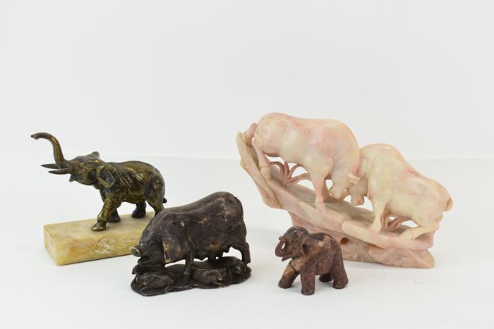 Four Assorted Animal Figurines: Four Assorted Animal Figurines including a hard stone carved fighting bulls, a hard stone elephant, a mother pig and piglets, and a brass elephant on a hardstone base Used condition, wear, worn, surfa