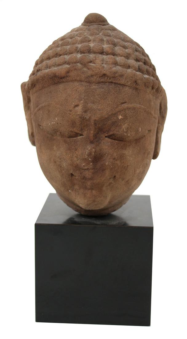 Asian Carved Stone Head: On contemporary stone base Head: appx. 7-1/2"h x 5"w Overall: 12"h x 4-1/2"w x 4-1/2"d Provenance: Art India, Delhi; Property from the Estates of David and Laura Finn, Westchester County, NY