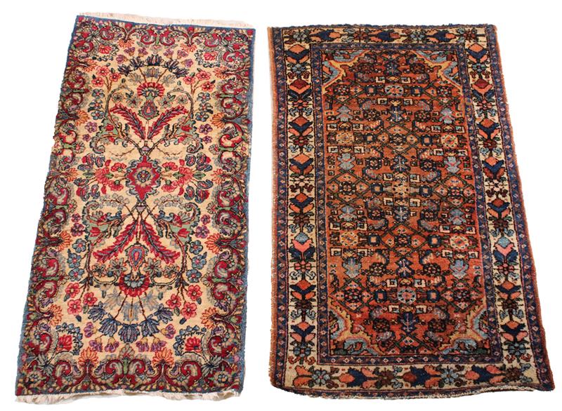 Hamadan Rug and a Kerman Rug: Northwest and Southeast Persia respectively, mid-20th C.: one blue, magenta, and ivory, the other rust, blue, and ivory. Wear, fading, losses to fringe. 48-1/2"l x 30"w and 47"l x 23-1/2"w