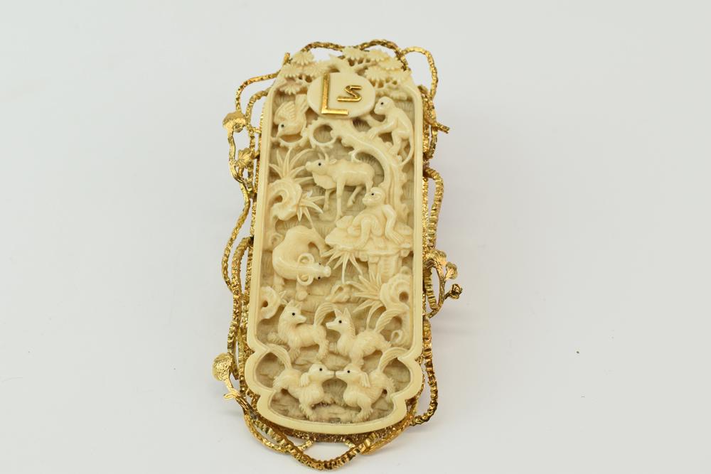 Gold Tone Metal Mounted Carved Bone Pendant: Gold tone metal mounted animal carved bone pendant, signed Pablo, engraved metal back and bail, 4"h x 2-1/4"w, used.