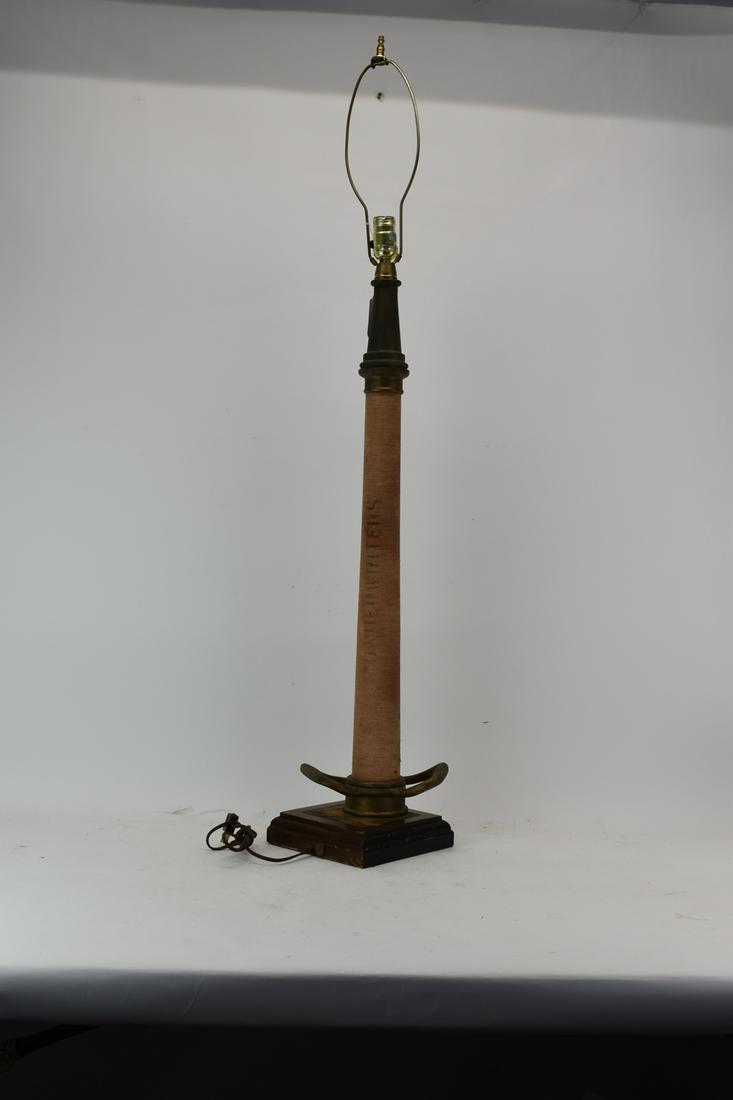 Vintage Fire Hose Form Table Lamp: Vintage Fire Hose Form Table Lamp. Used condition, wear, worn, base not original to piece. 46 1/2" tall to top of harp