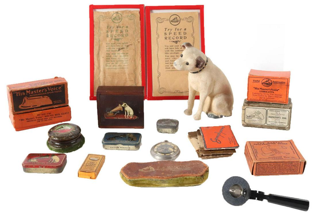 Group of RCA Victor Boxed Accessories: Including a RCA Victor pocket watch, a Nipper still bank, three RCA Victor needle cases, a RCCA wooden box, a record cleaner, two New Old Stock speed testers, and others, appx. 21 pieces total