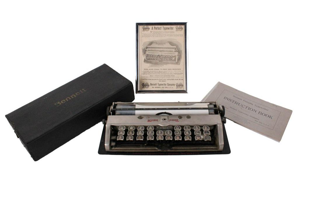 Bennett Portable Typewriter: In silver paint with leather portable cover embossed "Bennett", together with a Bennett portable typewriter instruction book and a frame 1910 Bennett advertisement 2"h x 11"w x 5"d
