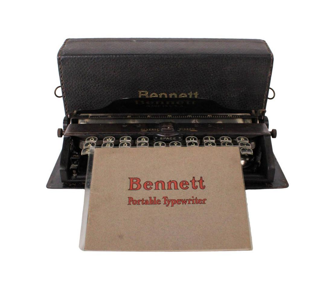 Bennett Portable Typewriter: In black enamel finish with leather portable cover embossed "Bennett", together with a Bennett portable typewriter instruction book 2"h x 11"w x 5"d