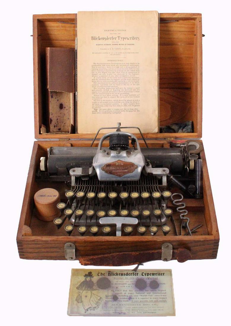 Blickensderfer Portable Typewriter No. 6: ca. 1906, in its original oak carrying case, virtually identical to model no. 5 but with an aluminum frame, together with an instruction manual and an advertisement for a Gold Medal Case: 7-1/2"h x 13