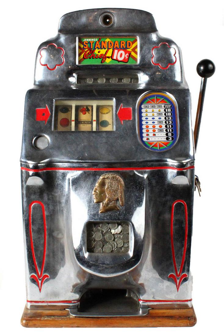 Jennings "Standard Chief" Slot Machine: 1946, 10 cent machine, with Jennings sticker on both sides, in working condition, includes key; together with The Coin Slot Guide to Kennings Club Chief and Standard Chief 27-1/2"h x 15"w x 16"d