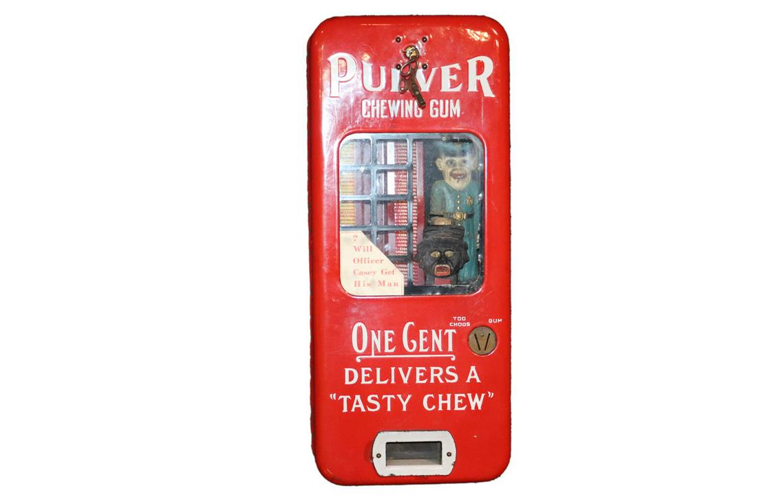 Black Americana Pulver Chewing Gum Machine: ca. 1940, with slogan "Will Officer Casey Get His Man?" in working condition 20-1/2"h x 9"w