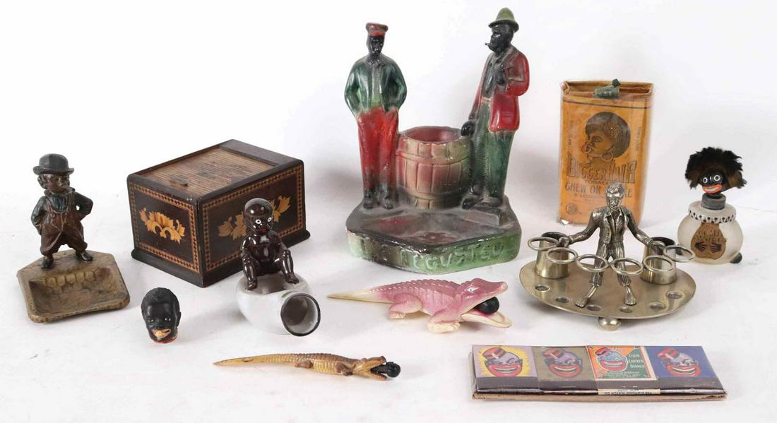 Group of Black Americana Tobacco Novelties: Including a silver-plated cigar holder of a Black man holding six rings, a rare package of B. Leidersdorf Co. "Bigger Hair" tobacco, an inlaid wood cigarette dispenser, a painted plaster ashtray, and 