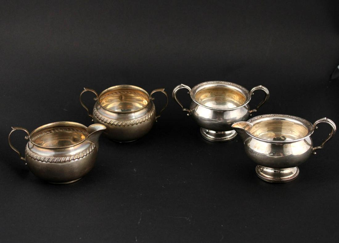 Two Sets of Sterling Silver Creamers and Sugars: Including one set by Fisher that is weighted, a sterling and glass wine bottle coaster, a Revere style sterling footed bowl, 1 3/4"h, a plated cigarette urn, a sterling creamer, a sterling weighted fo