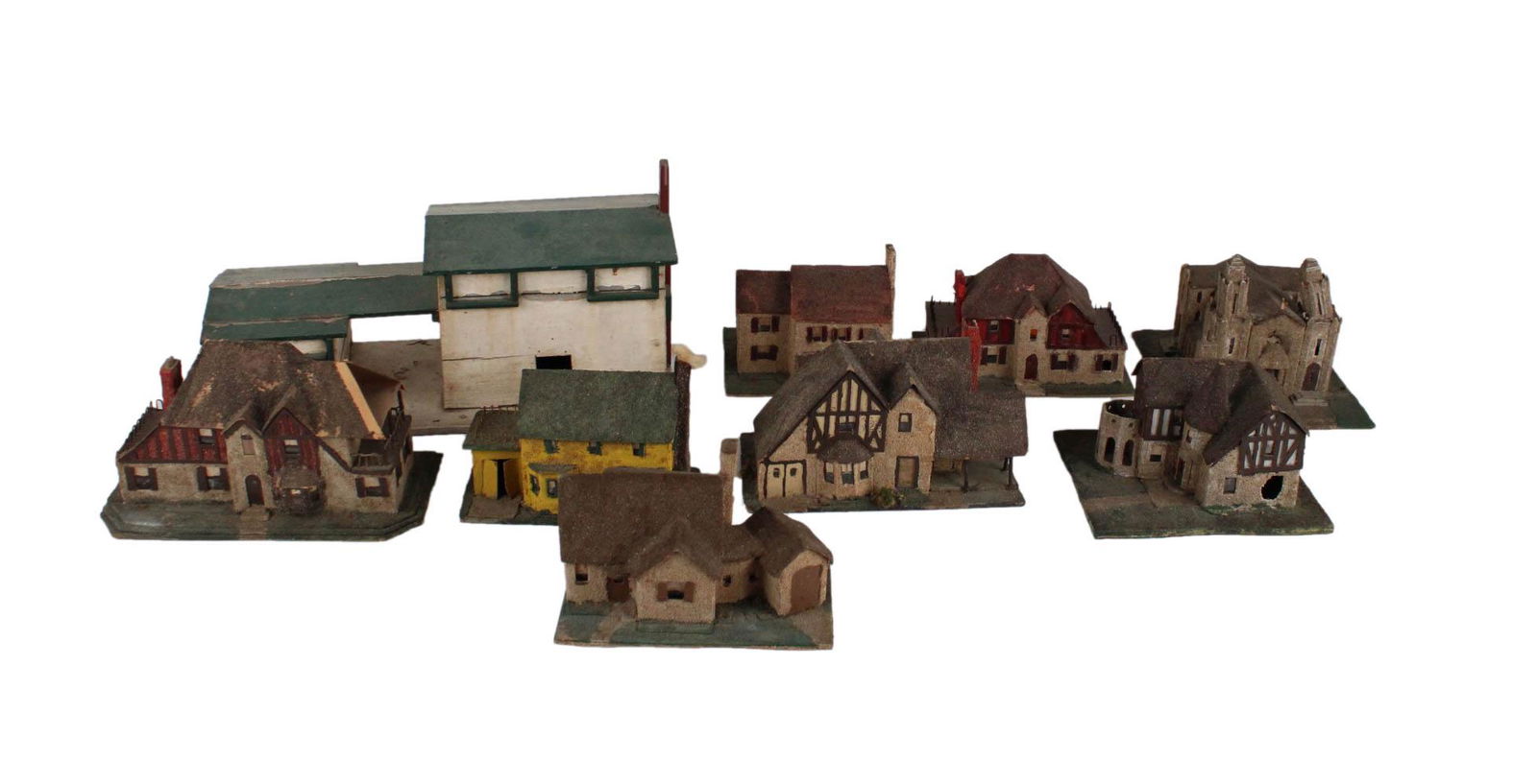 Papier Mache Model English Village: Comprising a set of Tudor and Georgian-style houses and a cathedral; together with a painted wooden garage and shed mounted on a wooden base, 9 pieces total Provenance: Property from the Estate of Edw
