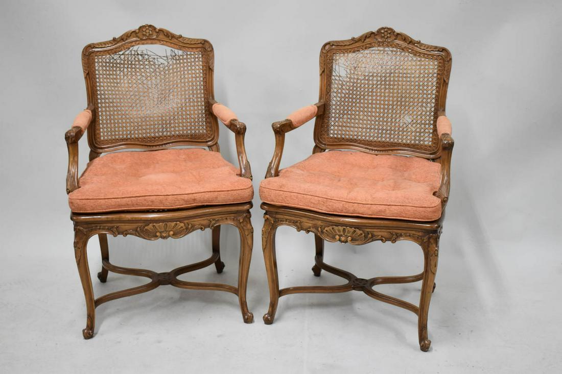 Pair of Louis XV Style Fruitwood Open Armchairs: Pair of Louis XV Style Fruitwood Open Armchairs, with caned seats, 19th/20th C., with peach upholstery. Losses, used condition, wear, worn. 38"h x 24"w x 19"d