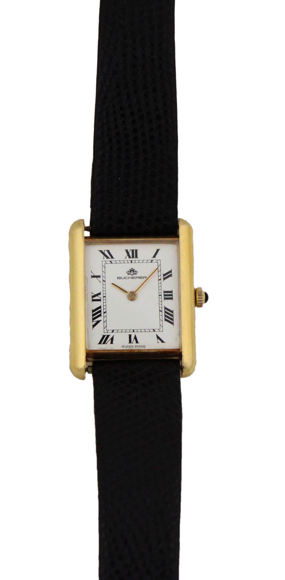 Bucherer 18K Yellow Gold Tank Watch: Mechanical movement, white dial with black Roman numerals, gold baton hands, and gold crown with a black onyx capstone, on a lizard strap