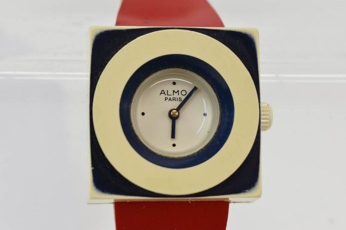 Vintage Art Deco ALMO Paris Square-Face Watch: Vintage Art Deco ALMO Paris Square-Face Watch having a square cream face with navy blue accents and a red vinyl strap with gold-tone buckle, marked "ALMO Paris" on face, back is marked "Model Depose M