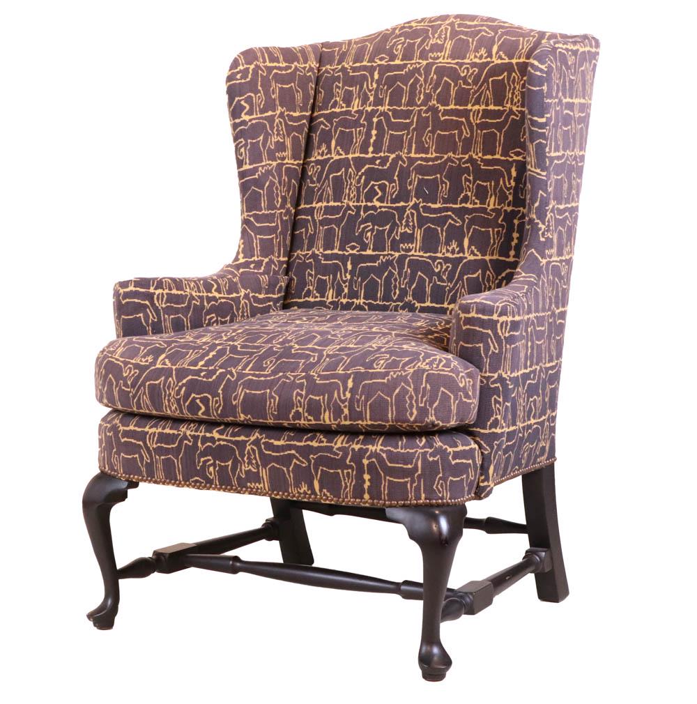 Queen Anne Style Ebonized Wing Chair: 20th C., with animal-outline brown fabric. Some wear and surface distress. 46"h x 35"w x 25"d Provenance: Doyle at Home, Sale 18FD04, Lot 441