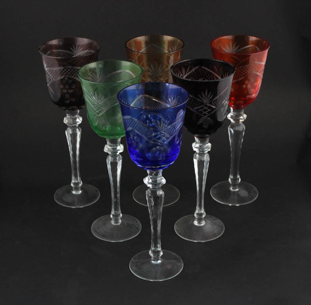 Thirty-Four Colored Cut to Clear Wine Glasses: Including red, orange, yellow, green, blue, and purple. Chips, wear, one lacking base. Each 9-3/4"h x 3-1/2"dia Provenance: Bonhams Los Angeles, October 24th, 2010, Lots 7707 and 7578