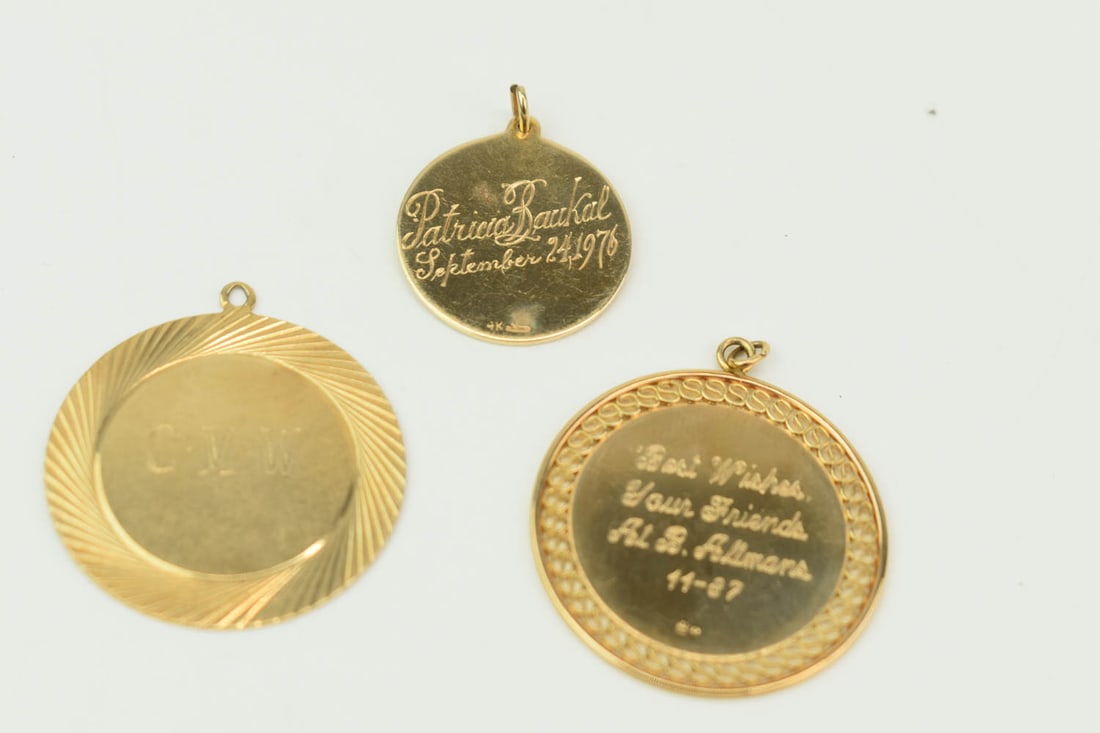 Three 14K Yellow Gold Circular Medallions: Three 14K Yellow Gold Circular Medallions, All stamped, "14K" and all with monograms or inscriptions. largest 1.5" diameter and approx. 10.46 dwt.