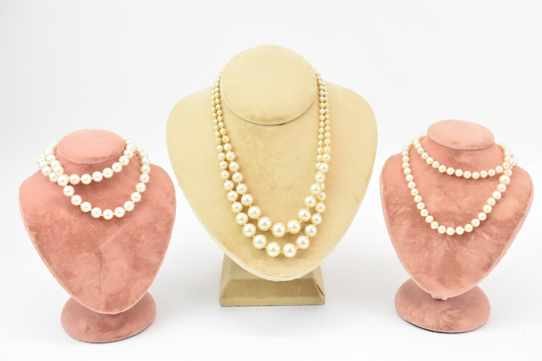 Strand 6-7.5mm Cultured Pearl Necklace: Strand 6-7.5mm Cultured Pearl Necklace , slightly graduated, 20"l. Together with 7.5mm faux pearl necklace, 18"l, and double strand faux pearl graduated necklace, worn, used.