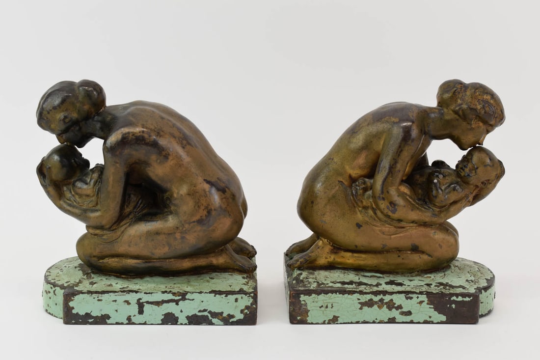 Sculptural Patinated Metal "Mother" Bookends: Sculptural Patinated Metal "Mother" Bookends, featuring a mother cradling and infant while bestowing a kiss to its forehead. Embossed "MOTHER" at front of each plinth. Surface wear and patina, paint l