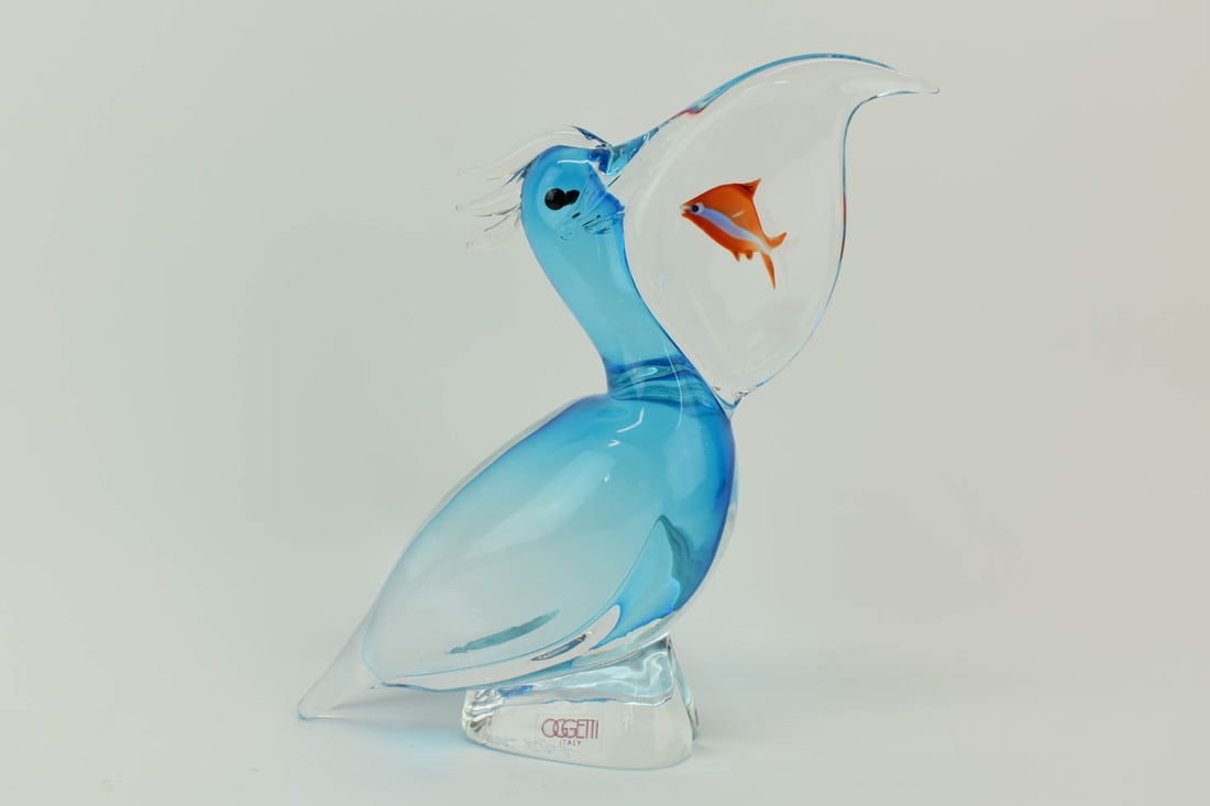 Signed Elio Raffaeli Art Glass Oggetti Pelican: Signed Elio Raffaeli Art Glass Oggetti Pelican with fish within his beak, appears to be in good condition free from chips or cracks. Dimensions: 9-3/4"h x 6-1/2"w x 2-3/8"d.