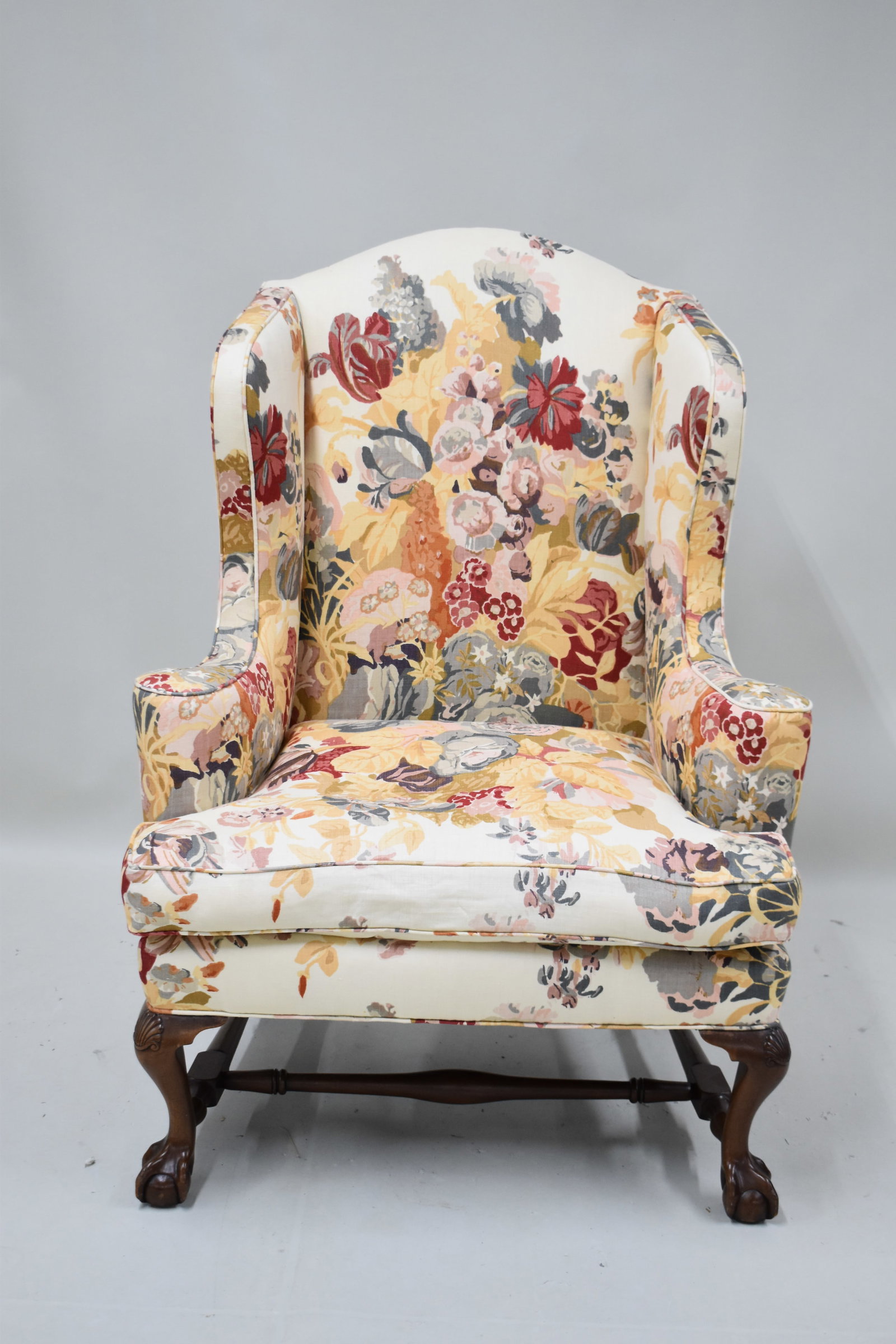 Chippendale Style Floral Upholstered Wing Chair: Chippendale Style Floral Upholstered Wing Chair. Used condition, minor staining to fabric. 49 1/2" tall x 36 1/2" wide x 30" deep x 23" tall to top of cushion.