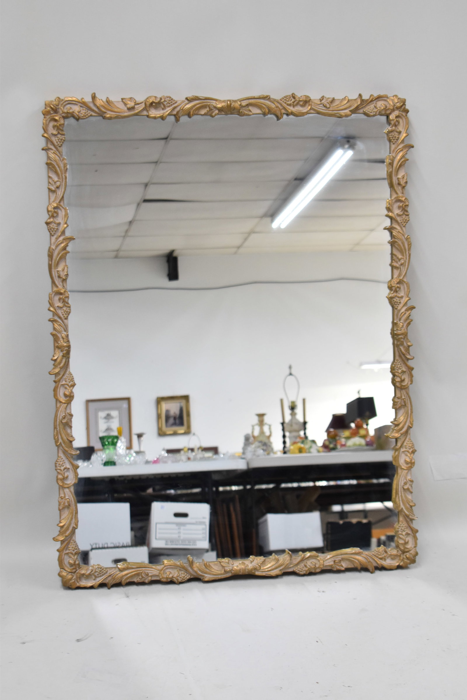 Vintage Gilt Carved Hanging Wall Mirror: Vintage Gilt Carved Hanging Wall Mirror, having grape and vine motif. Used condition, some cracks to gilt frame. 43" x 33"