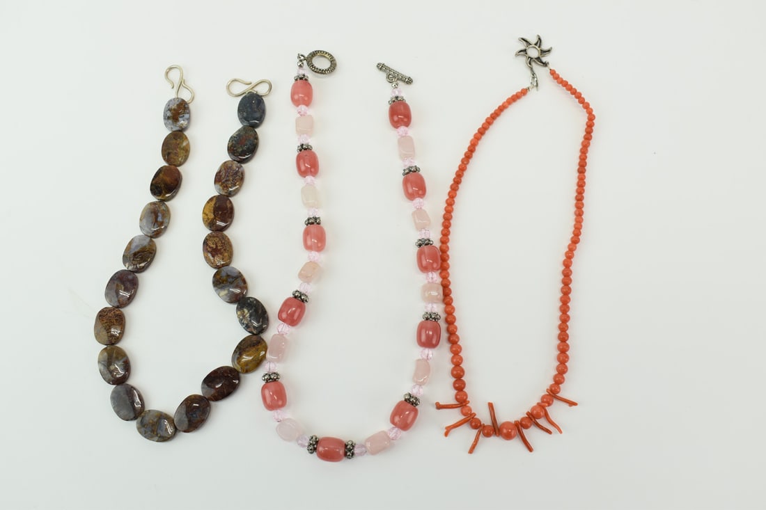 Coral Beaded Necklace With Sun Toggle Closure: Coral Beaded Necklace With Stylized Sun Toggle Closure together with a flat oval hardstone beaded necklace with silvertone hook closure, and a pink glass and silvertone beaded necklace with toggle clo