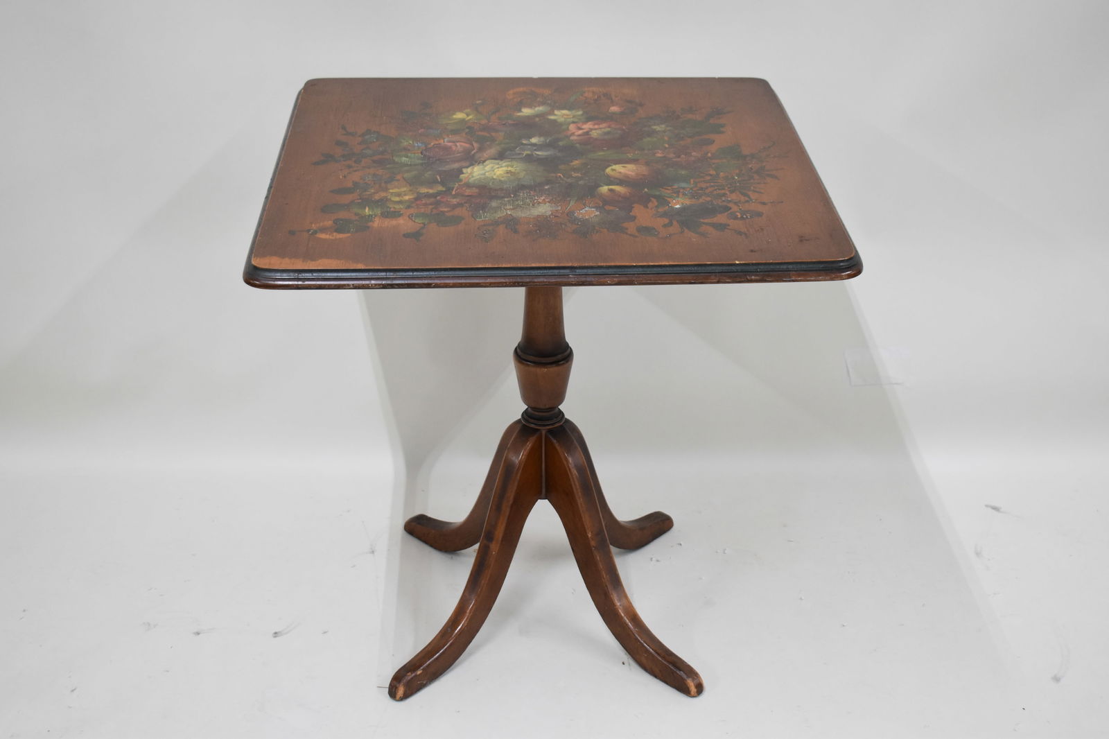 Country Floral Decoupage Tilt-top Table: Country Floral Decoupage Tilt-top Table, in used condition wear/worn, some losses along edges of feet, water marks on top, light losses to decoupage. Dimensions: 26-3/4"h x 25-3/4" x 25-3/4"