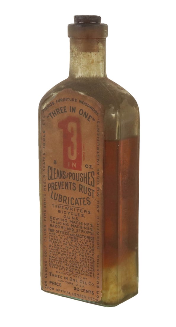 Early Bottle of 3-in-1 Oil: 6oz bottle, made by the Three in One Oil Co. between 1905 and 1910, still contains some oil. Wear, losses to label. 7-1/2"h x 2-1/2"w x 1-1/2"d