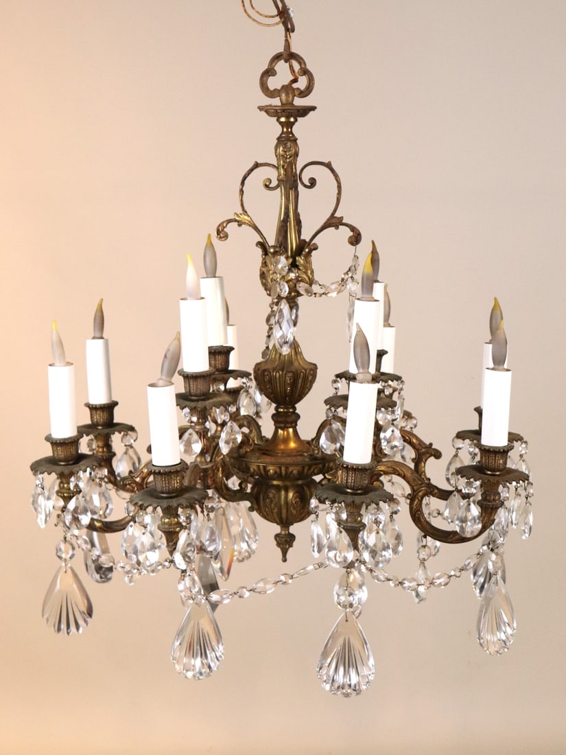 Louis XV Style Gilt-Metal 12 Light Chandelier: 20th C. with crystal swags and pendants. Some losses and wear. 29"h x 25-1/2"dia.