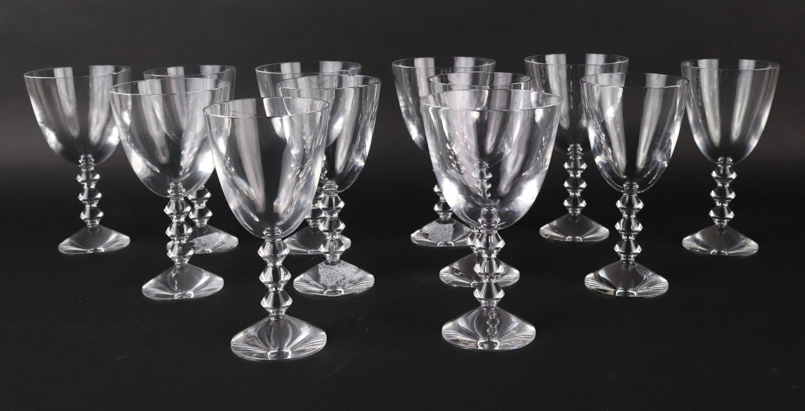 Twelve Baccarat Vega Crystal Glasses: Comprising, six water goblets and six wine glasses. Chips, wear. 7"h x 4"dia. and 7"h x 3-1/2"dia.