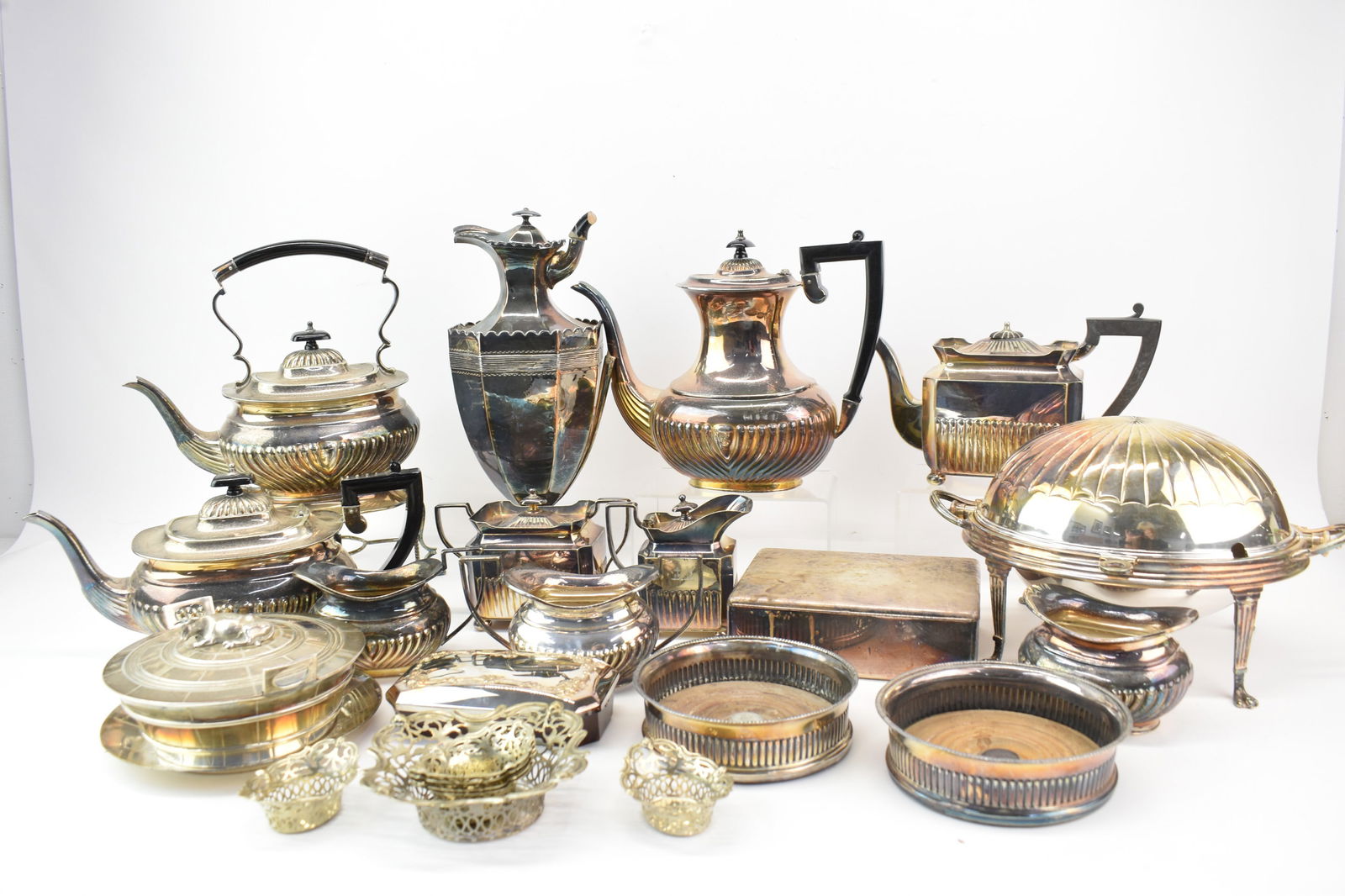 Large Group Assorted Silverplate Tea Serving Sets: Large Group Assorted Silverplate Tea Serving Sets together with large wood and silver wine coasters, footed food server, covered box, and clothes lint brush. All used condition, surface wear and scrat