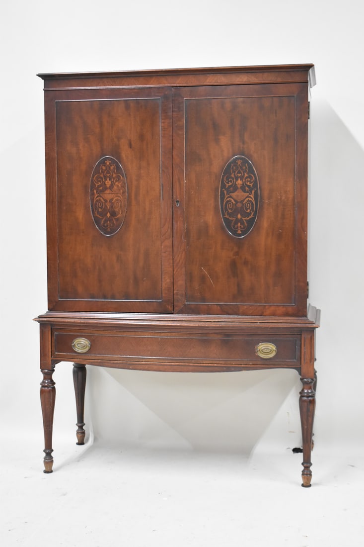 Mahogany Edwardian Style Two Door Cabinet: Mahogany Edwardian Style Two Door Cabinet having 2 doors with central urn inlay above a single drawer. Used condition, wear, worn. 54 1/4" tall x 38" wide x 17" deep