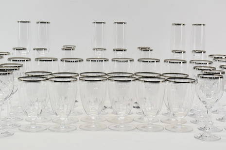 Large Set of Assorted Silver Rimmed Glasses: Large Set of Assorted Mikasa Colorless Glass Silver Rimmed Stemware. Comprising 16 Champagne's, 12 white wines, 12 red wines and 12 water glasses. All appear to be in unused condition. Water glasses m