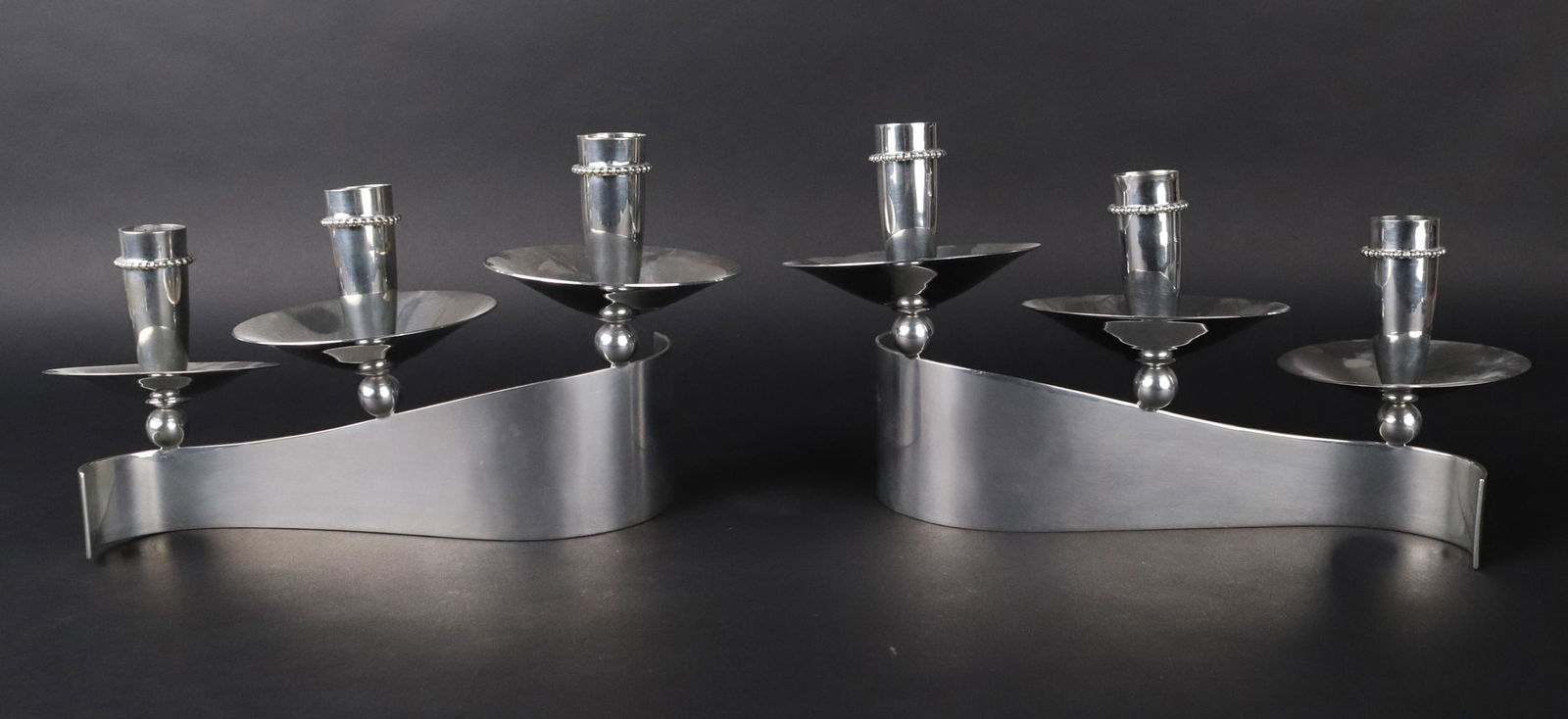 Pair of Royal Hickman Candlesticks: For Carole Stupell LTD. Pottstown, Pennsylvania, circa 1950s. Silver-plate stamped " Carole Stupell Exclusive, Royal Hickman" with three crown mark.Provenance: Property from a Private New York and Swi