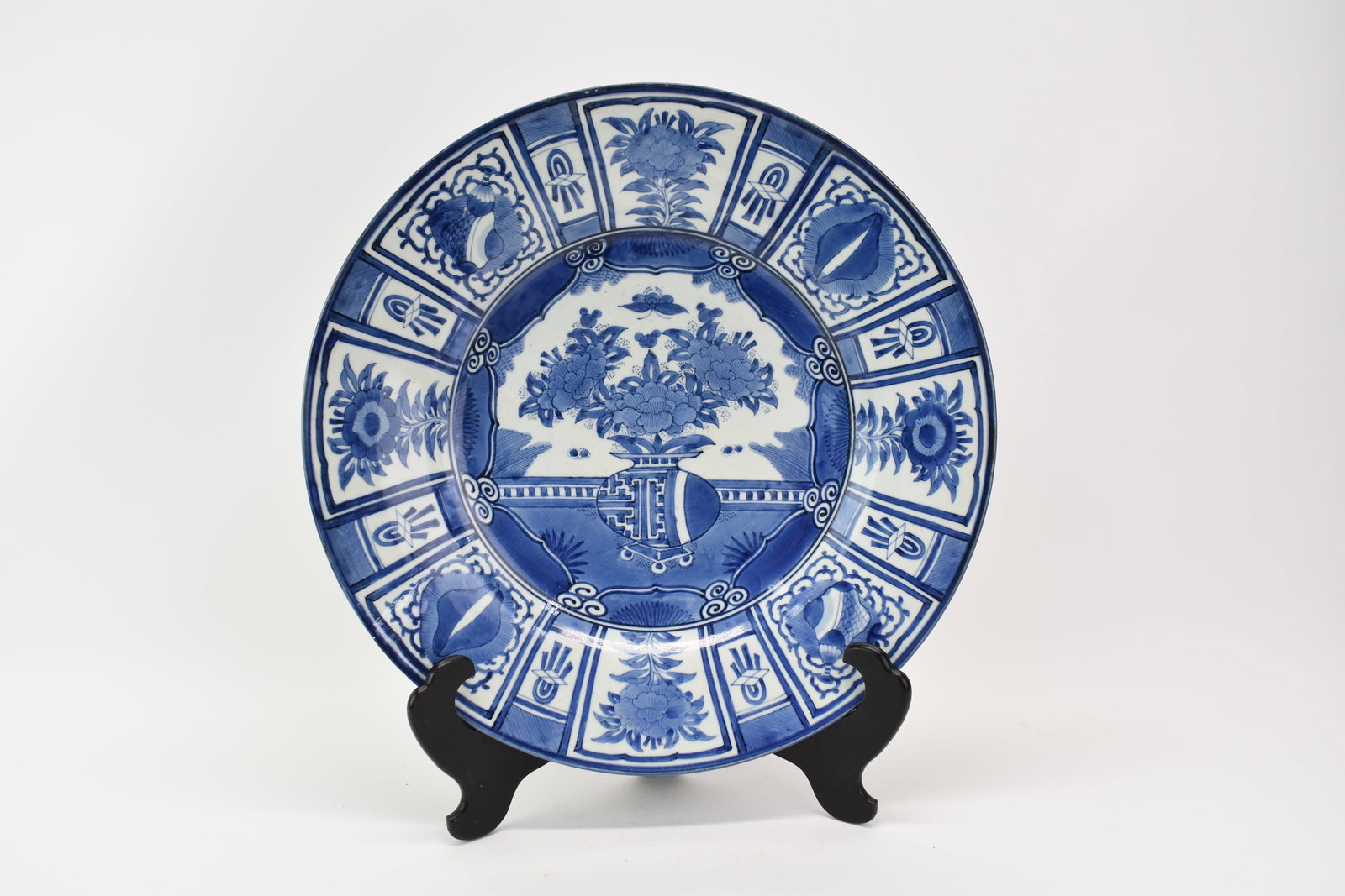 Asian Blue and White Decorated Charger: Asian Blue and White Decorated Charger Asian Blue and White Decorated Charger with central floral and urn motif. Used condition, small chip to rim, 18" diameter x 3"