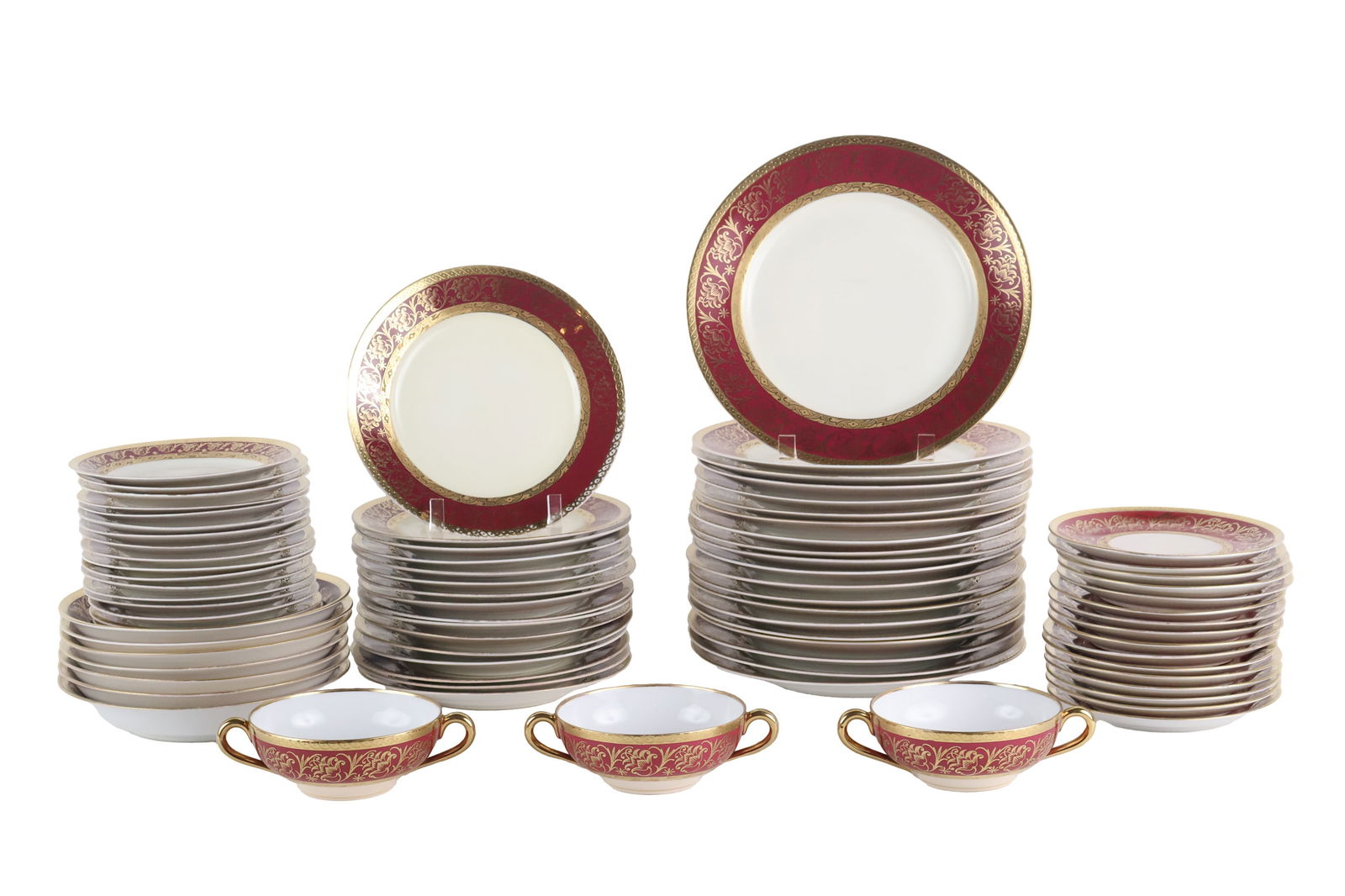 Holzner Karlesbad Red and Gilt Dinner Service: Holzner Karlesbad Red and Gilt Dinner ServiceMarked Puls Antoinette, Bohemia and Empire, comprising, 20 dinner plates, 16 luncheon plates, 7 bowls, 5 boullion cups and 16 saucers, and 17 bread plates.