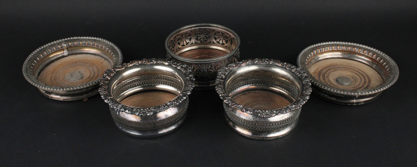 Two Vintage Pairs of Silver Plated Wine Bottle Coasters: Two Vintage Pairs of Silver Plated Wine Bottle CoastersTogether with a reticulated example. 8"dia., 7"dia., and 6"dia.