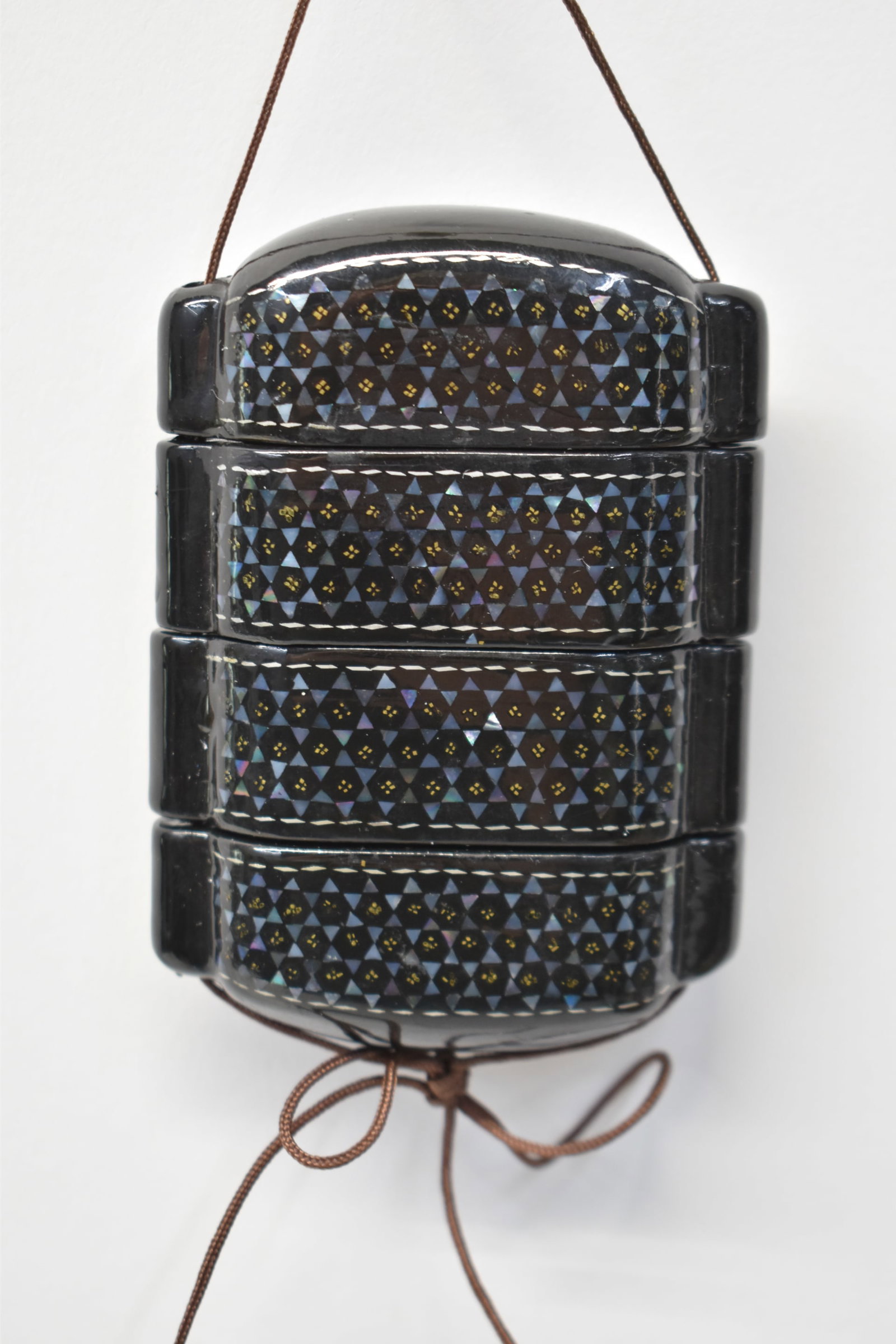 Japanese Black Lacquered Inro: Japanese Black Lacquered Inro Japanese Black Lacquered Inro with micro inlay of mother of pearl in geometric patterns and white bone Ojime that separates into four compartments. Used condition, some l