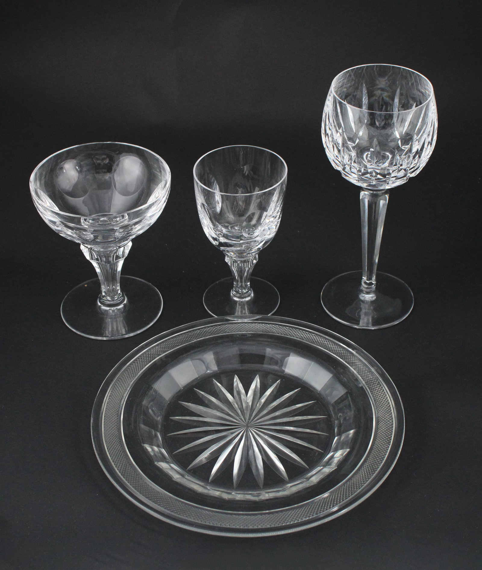 Eight Waterford Hock Wine Glasses: Eight Waterford Hock Wine Glasses Together with 14 port glasses, 4 coupe glasses, and 11 glass plates. 37 pieces Waterford: 7-1/2"h