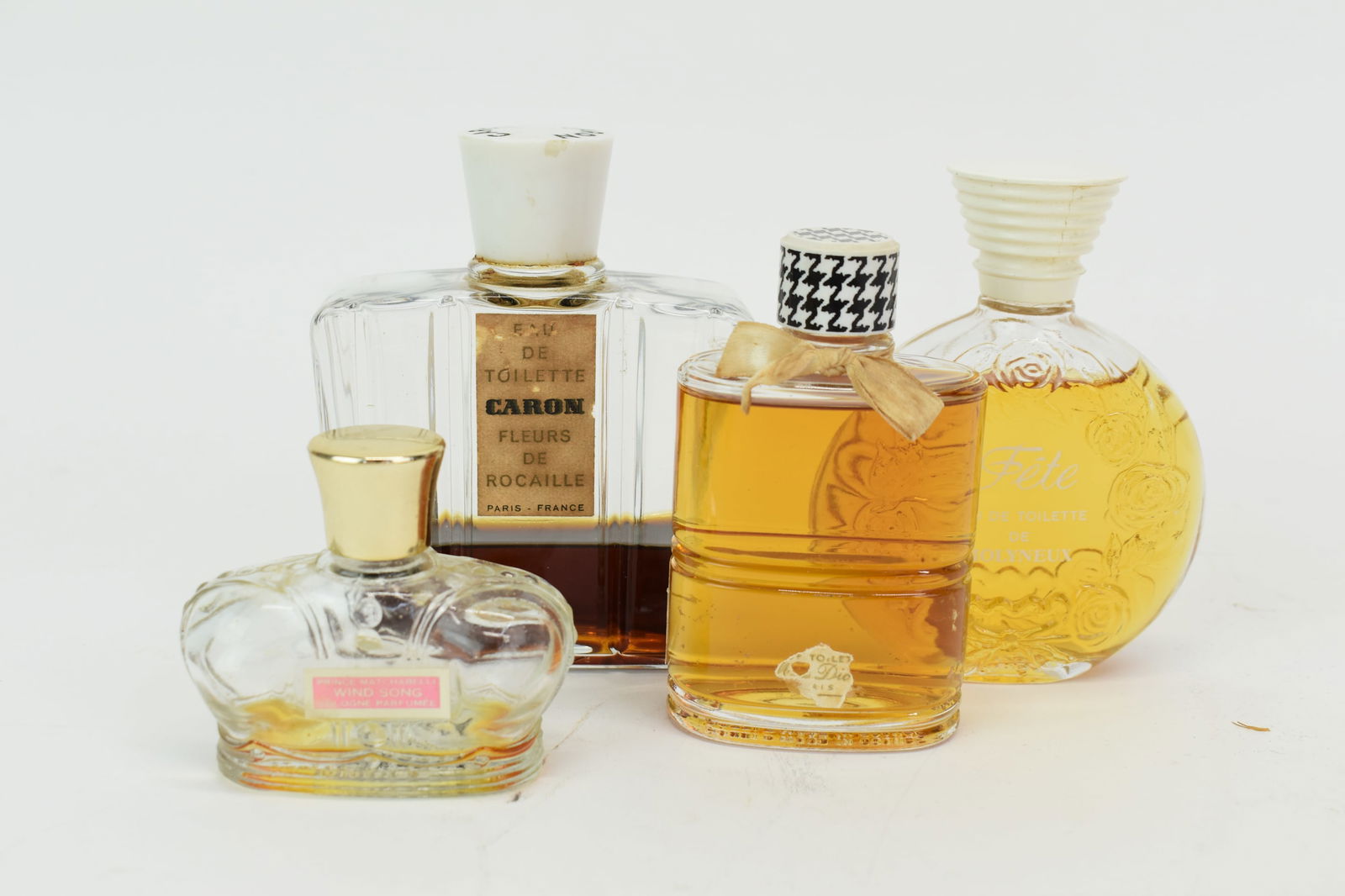 Four Vintage Ladies Perfume Bottles: Four Vintage Ladies Perfume BottlesFour Vintage Ladies Perfume Bottles comprising Caron Fleurs De Rocaille, Paris France, Miss Dior Christian Dior, Fete Eau De Toilette De Molyneux, and Price Matchave
