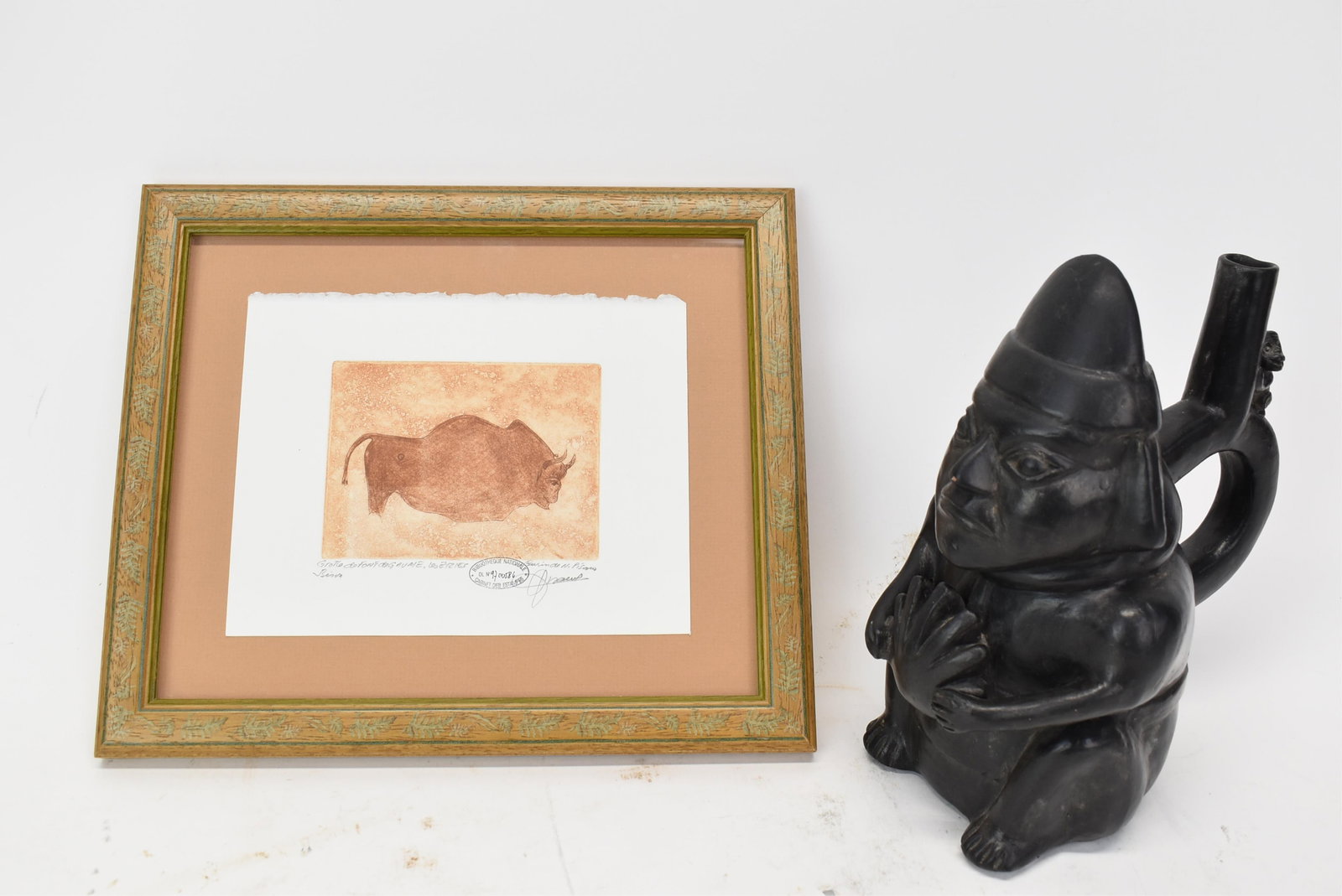 Reproduction Peruvian Tomb Jug: Reproduction Peruvian Tomb Jug20th C. Together with a print after a bison from the Lascaux cave. 2 pieces9 1/4 x 5 x 8 in. (23.5 x 12.7 x 20.3 cm.)