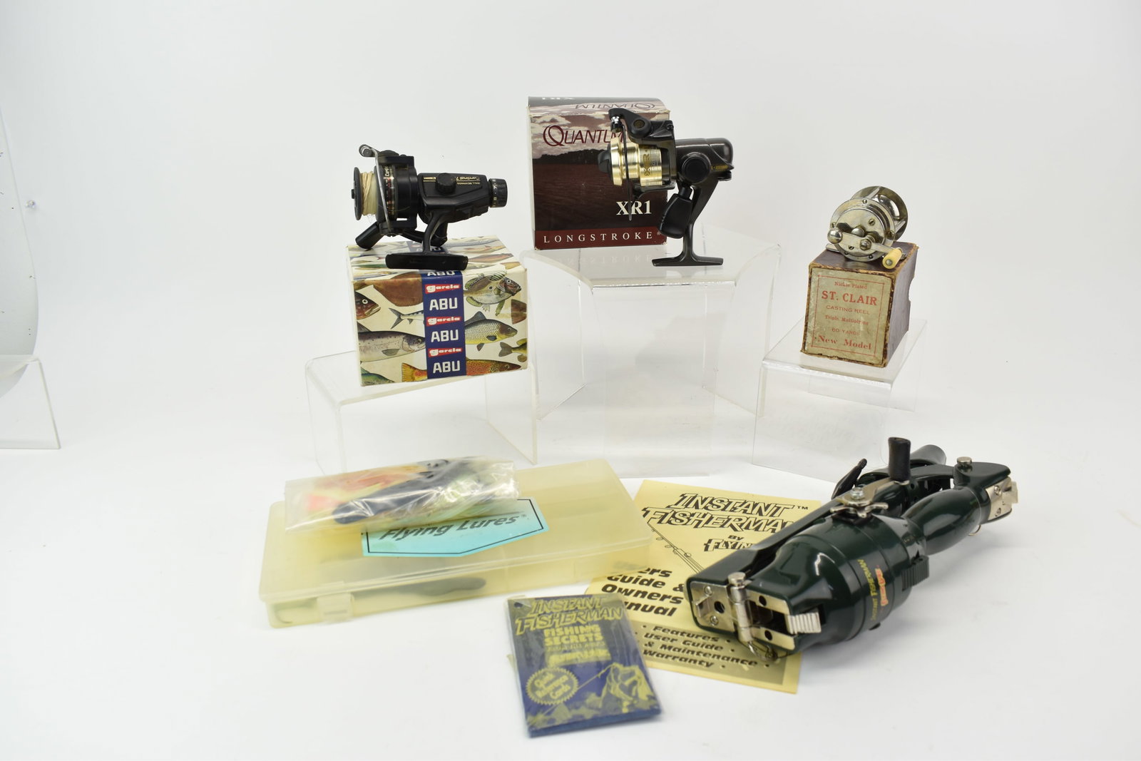 Group of Four Assorted Fishing Reels: Group of Four Assorted Fishing Reels Group of Four Assorted Fishing Reels. Comprising Instant Fisherman, Abu Garcia Cardinal 752, Quantum Longstroke XR1 and a St. Clair Casting Reel. Used condition,