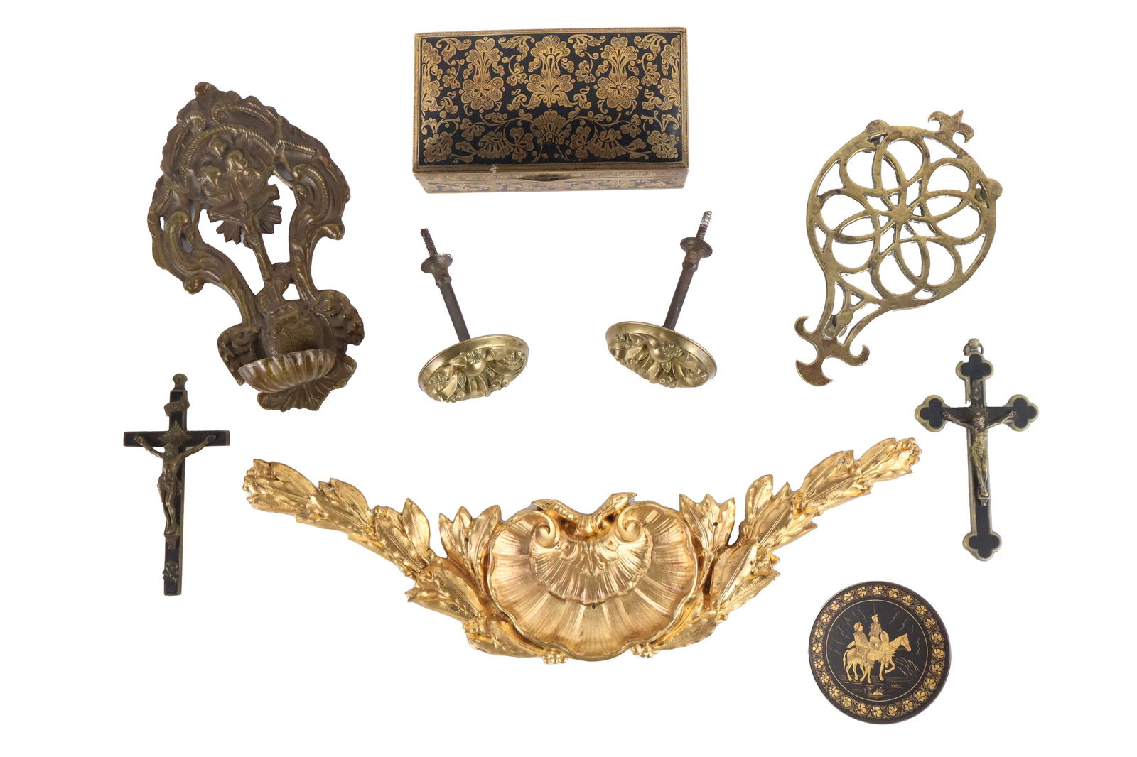 Cast Brass Wall-Mounted Font: Cast Brass Wall-Mounted FontContinental, 17th C. Together with two crucifixes, a brass trivet, two engraved brass items, an ormolu mount, two curtain tie-backs. 8 piecesFrom 3 in. (7.6 cm.), Frame: 16