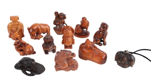 Twelve Figural Carved Wood or Composite Netsukes