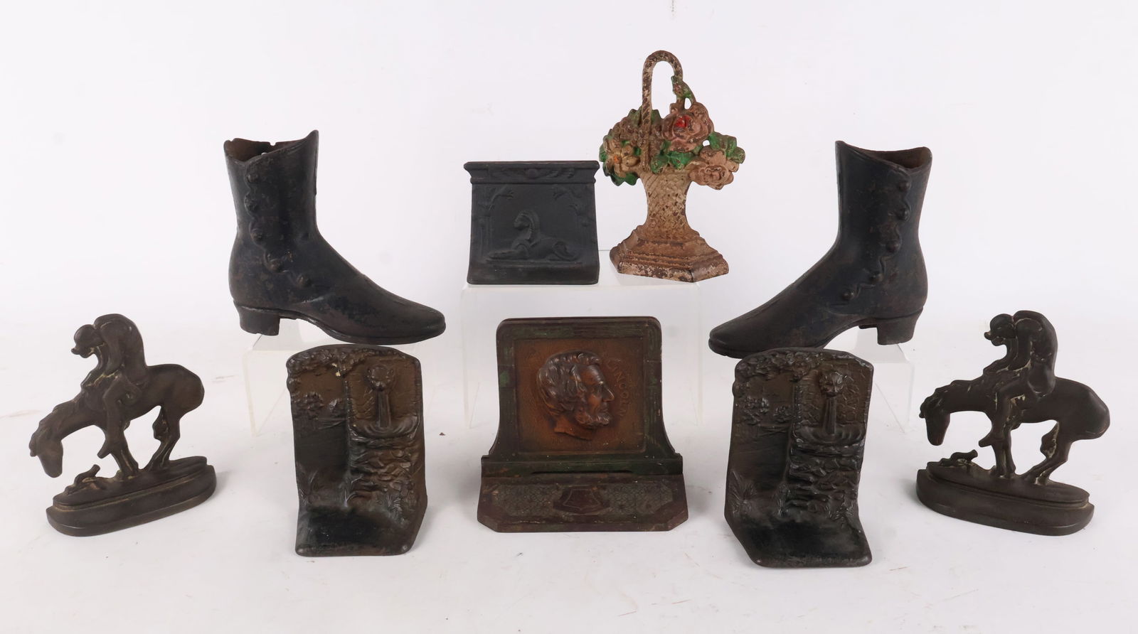 Group of Cast Iron Doorstops: Group of Cast Iron DoorstopsPair of casted George Washington doorstop; pair of casted Abraham Lincoln doorstop; pair of casted "End of the Trail" doorstop; pair of casted fountain scene door