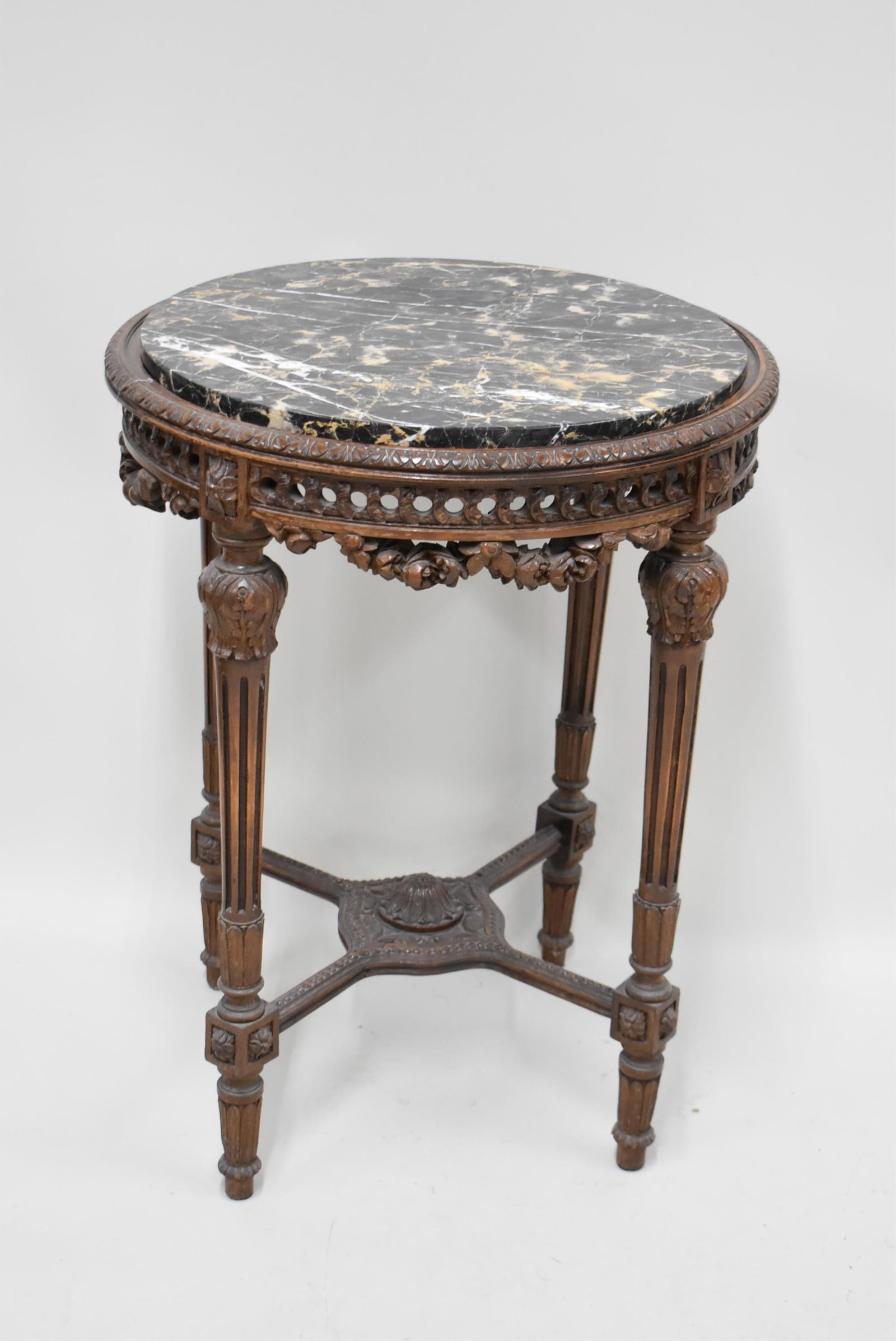 Italian Marble Top Occasional Table: Italian Marble Top Occasional Table Italian Marble Top Occasional Table, resting on fluted columns and a stretcher base. Used condition, wear, worn, chips to marble, surface distress, 30 1/2'" ta