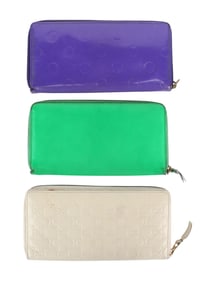 Three Comme des Garcons Zippered Wallets