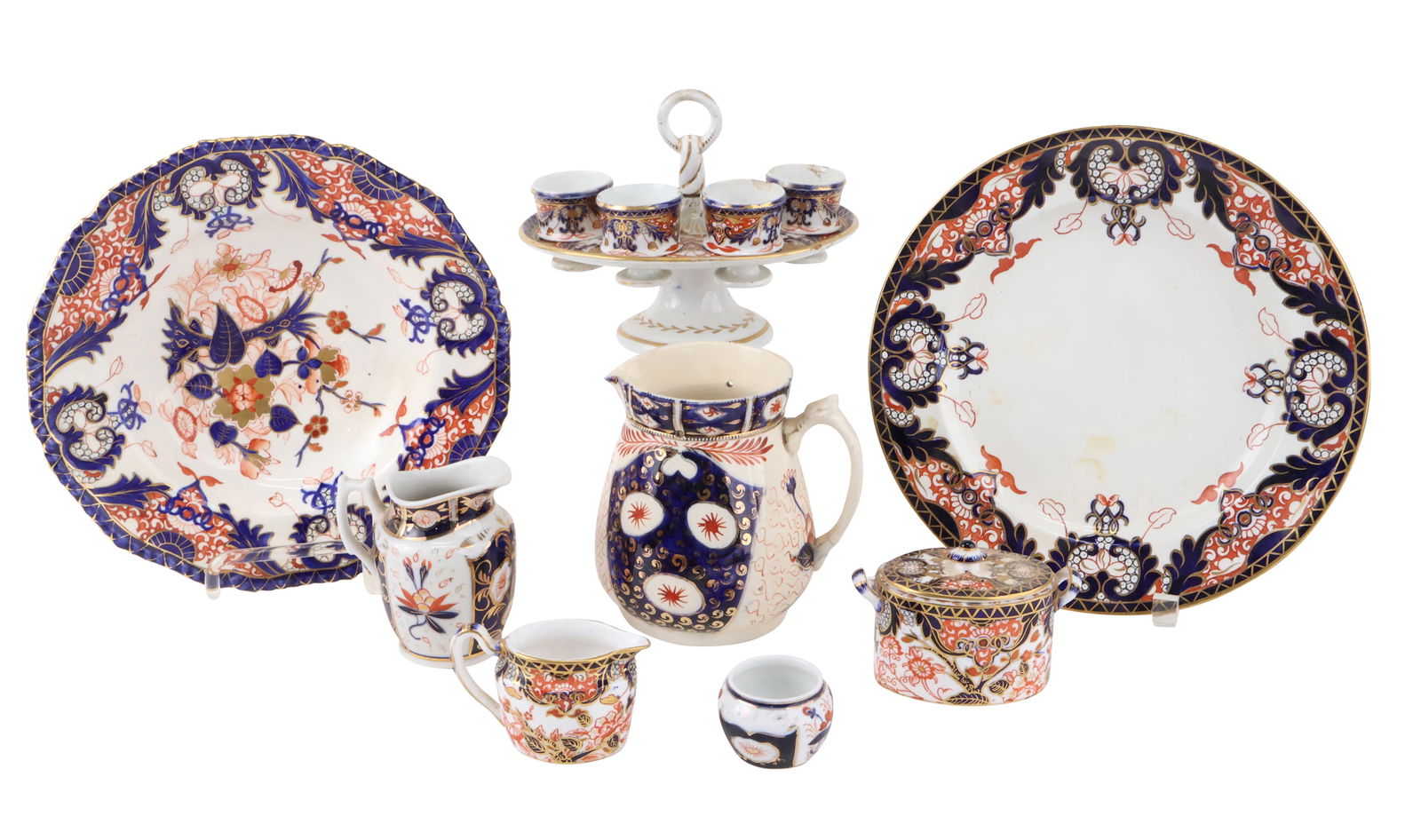 Imari Porcelain Egg Stand: Imari Porcelain Egg StandTogether with a group of imari porcelain, including, two plates, creamers, pitchers, and a covered dish. 8 piecesMissing two egg cups, chips, losses.Egg Stand: 5 1/2 x 8 x 6 i