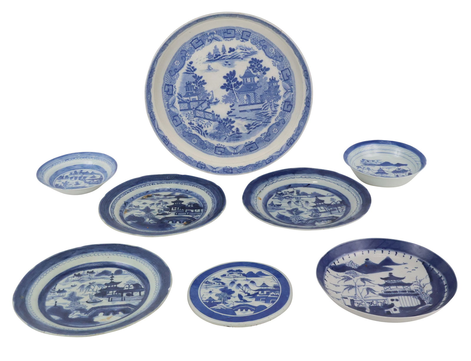 Eleven Chinese Blue Canton Porcelain Table Articles: Eleven Chinese Blue Canton Porcelain Table ArticlesIncluding, a platter, a footed platter, a punch bowl, a trivet, and dishes.Chips, wear, surface distress.Platter: 1 3/4 x 15 3/4 x 13 in. (4.4 x 40 x